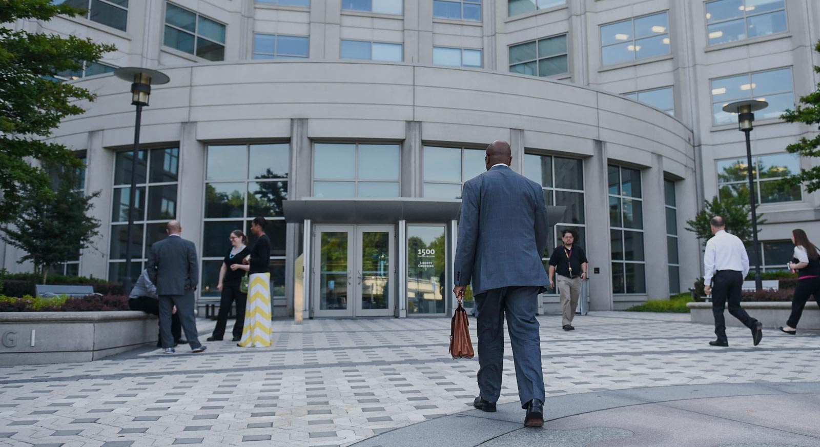 Workers standing near building entrance